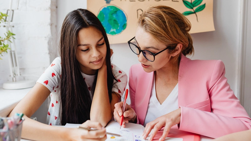An image of a student getting feedback from her mentor