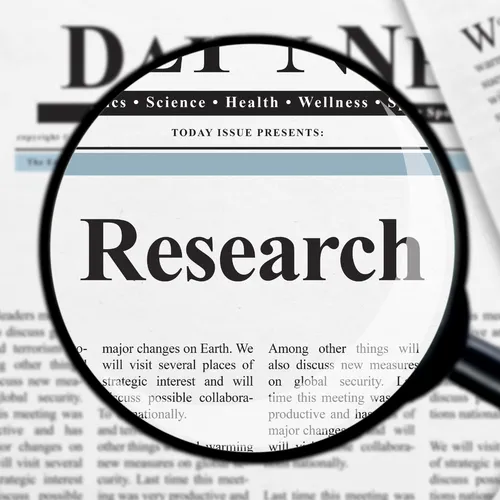 An image of a magnifying lens on the word research