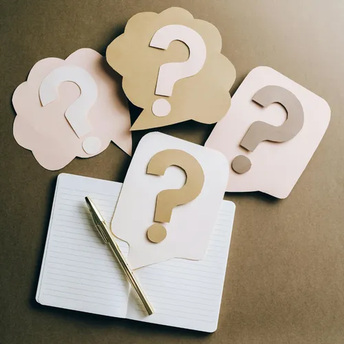 An image of question marks on a research paper